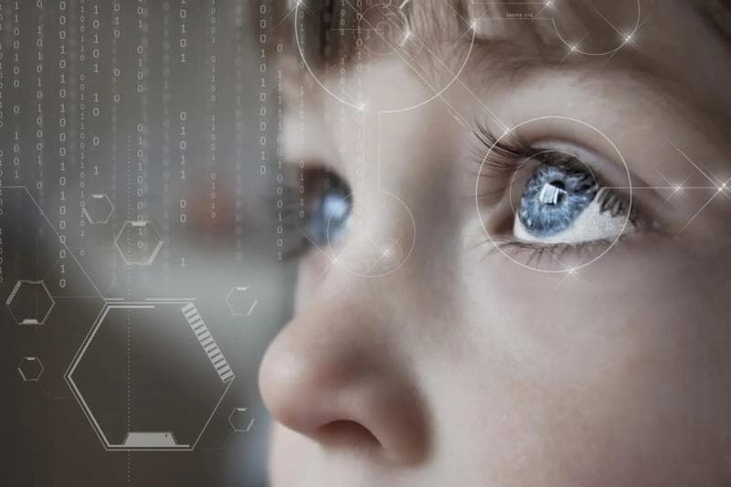 Child with blue eyes looking at the horizon with white graphic elements over the image.