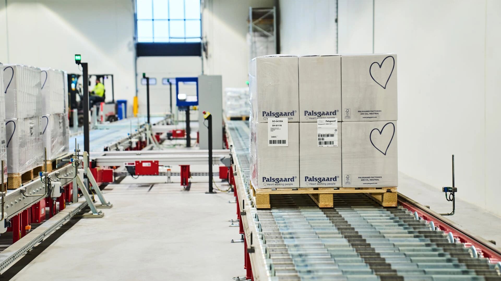 Automation systems inside a warehouse transporting boxes.
