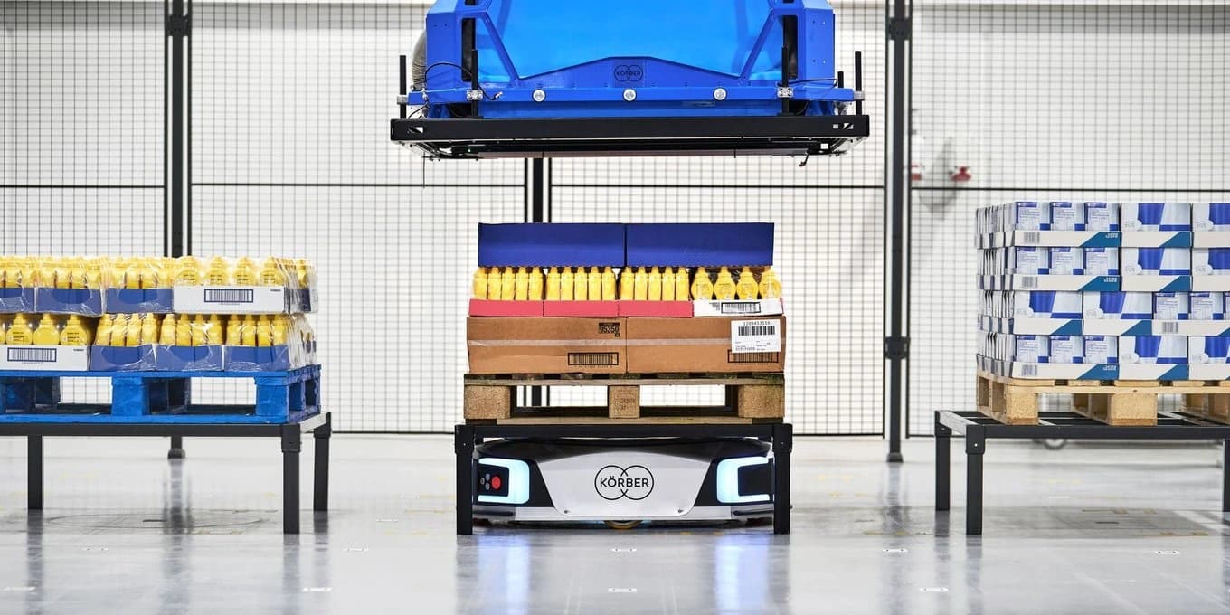 A blue and yellow robot rests on a shelf, showcasing its role in logistics and AMR software.