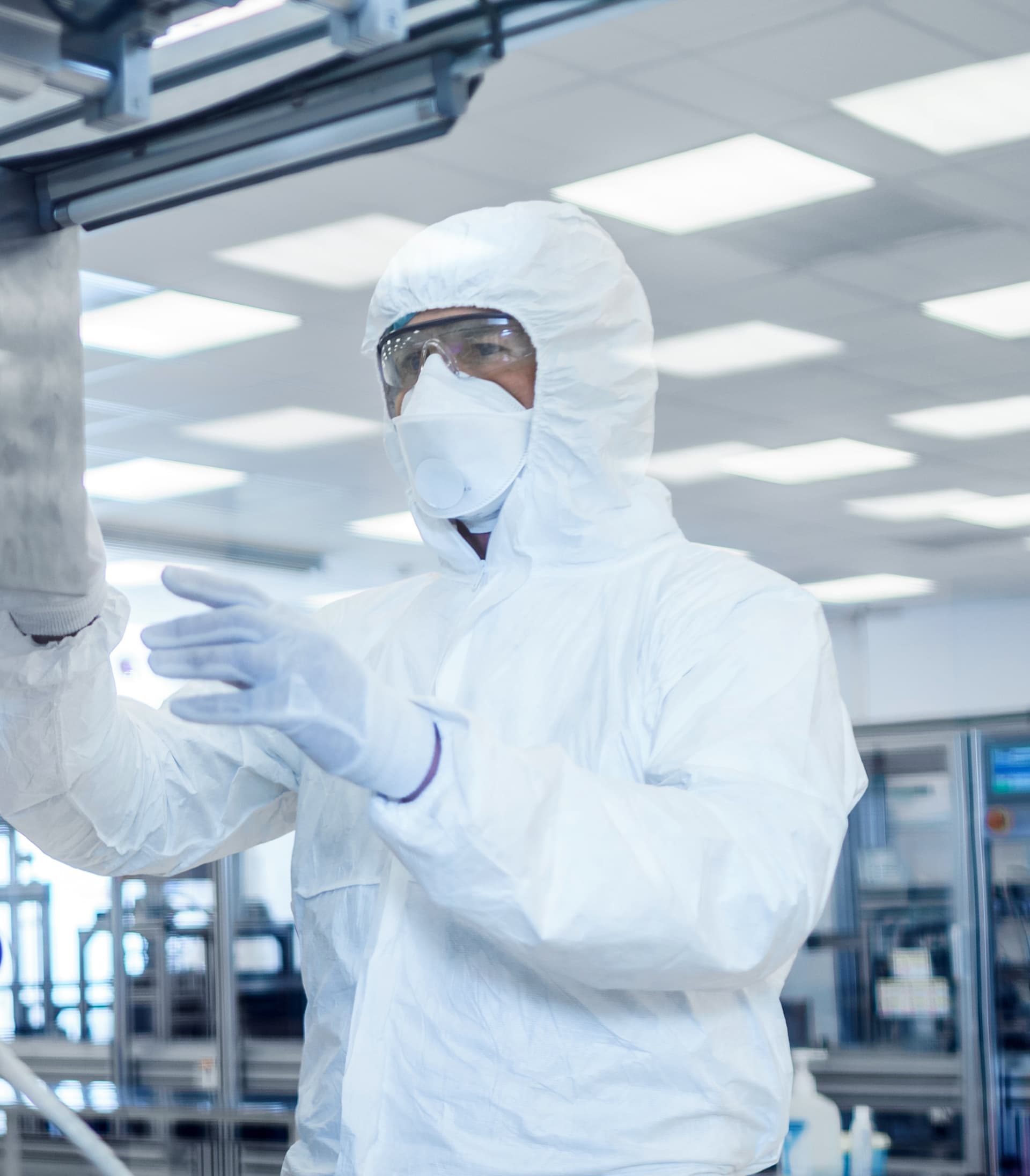 Person in personal protective equipment working in a lab