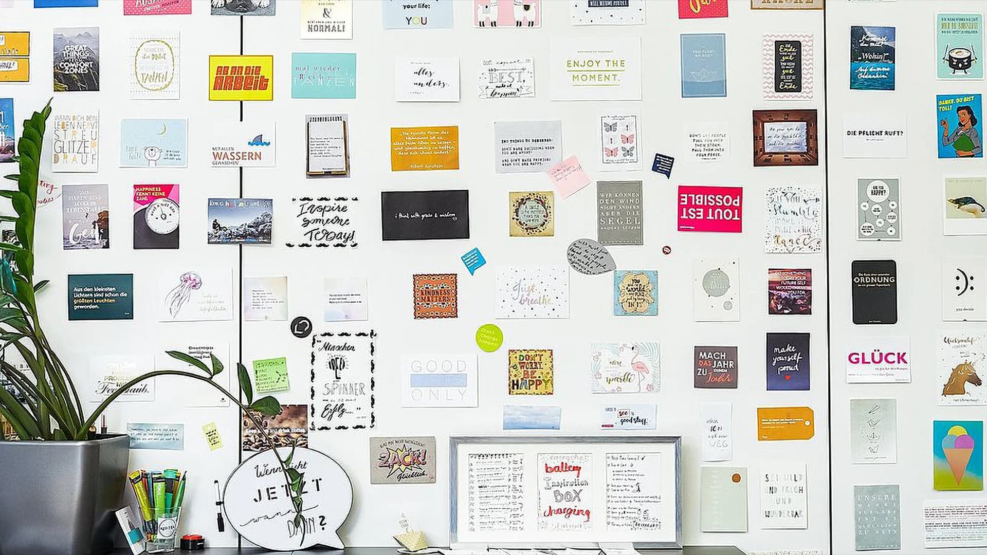 A wall covered with postcards