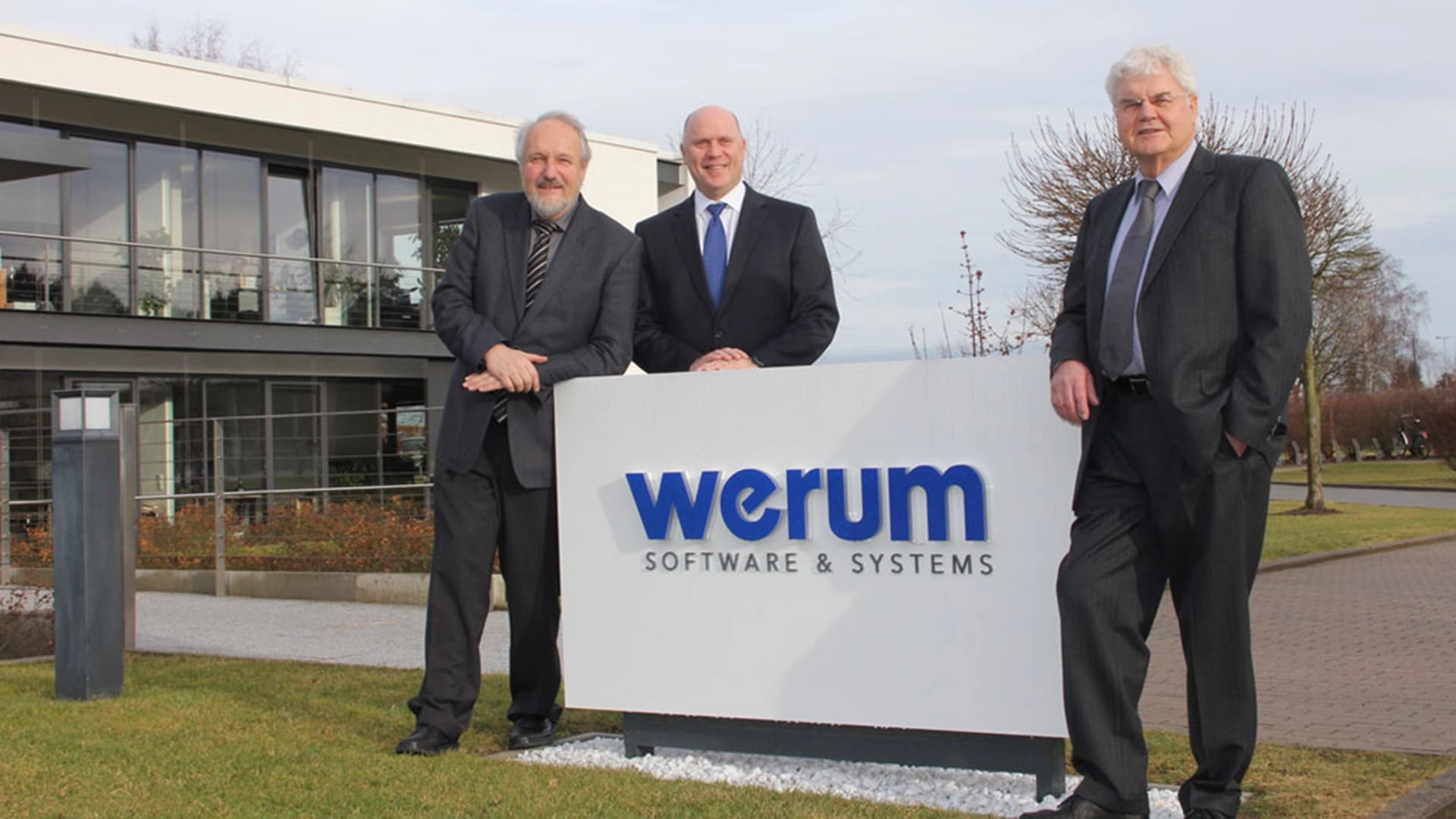 Werum's CEO stands with his team, highlighting Körber AG's upcoming acquisition of the company.