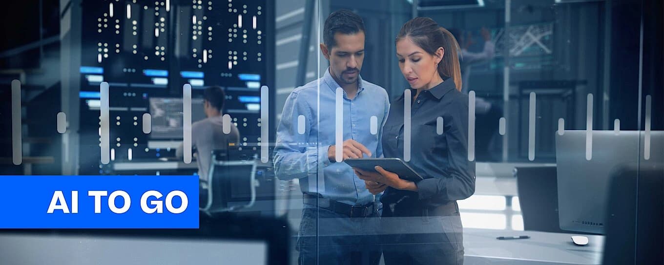 A man and a woman with a tablet on her hands discussing business. 
