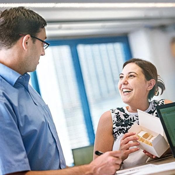 Man and woman talking and smiling to each other.