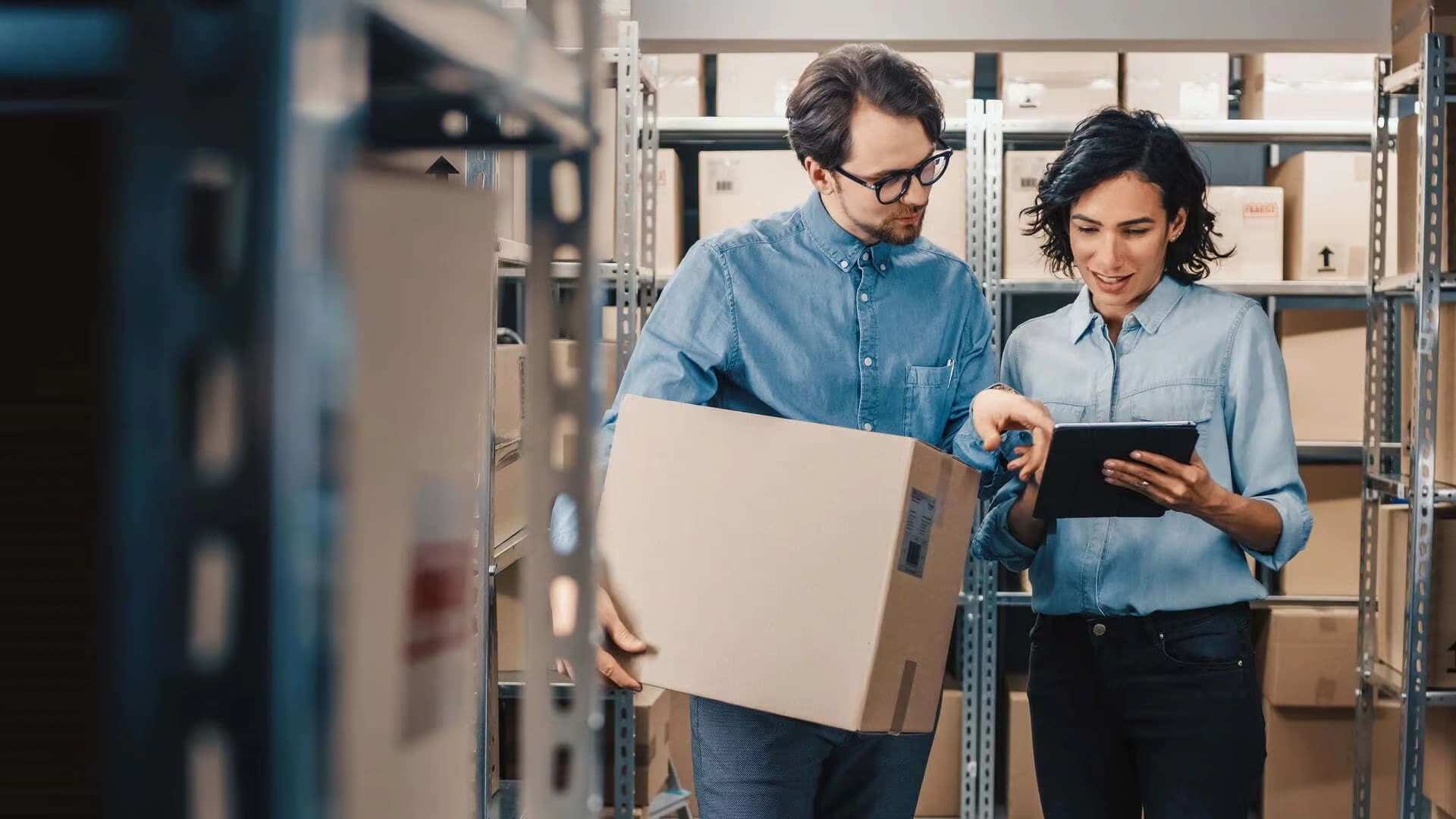 two people working on a parcel & mail software