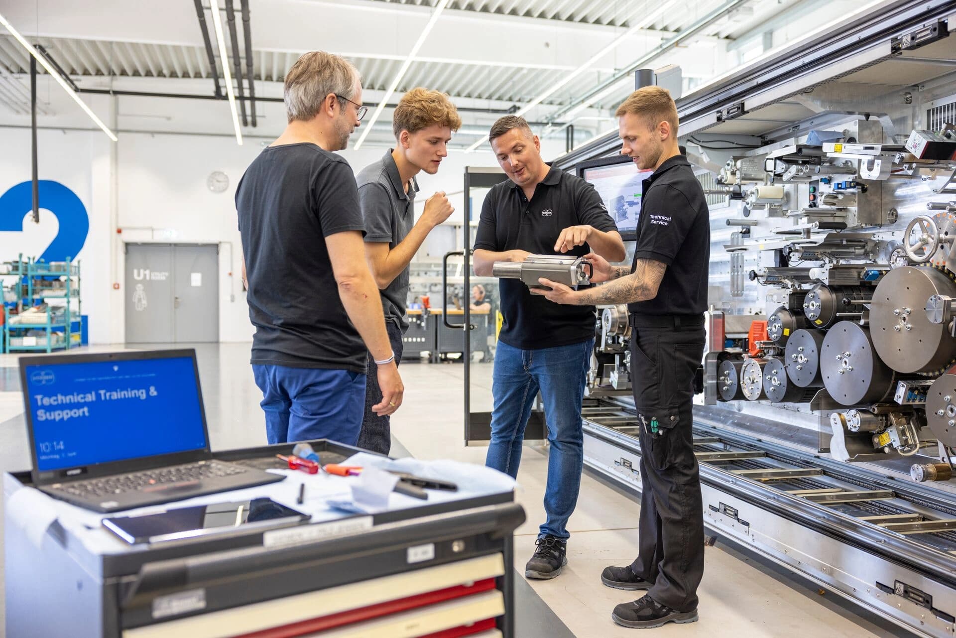 Group of Körber employees checking an instrument.