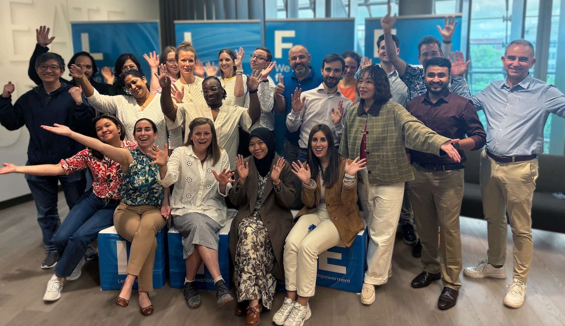 A group of Körber employees smiling and posing together