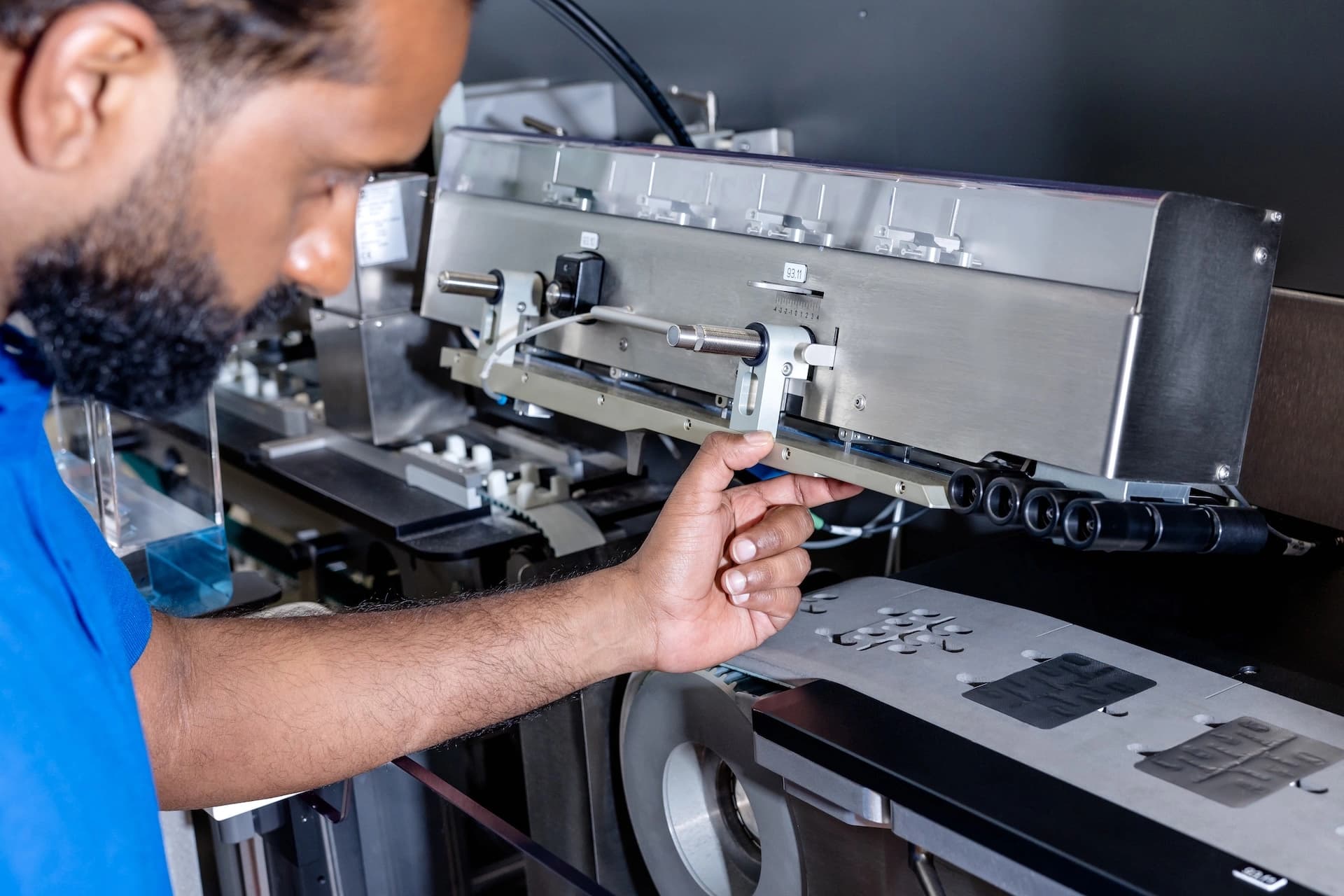 a Körber employee working on blister packaging machine for oral solids