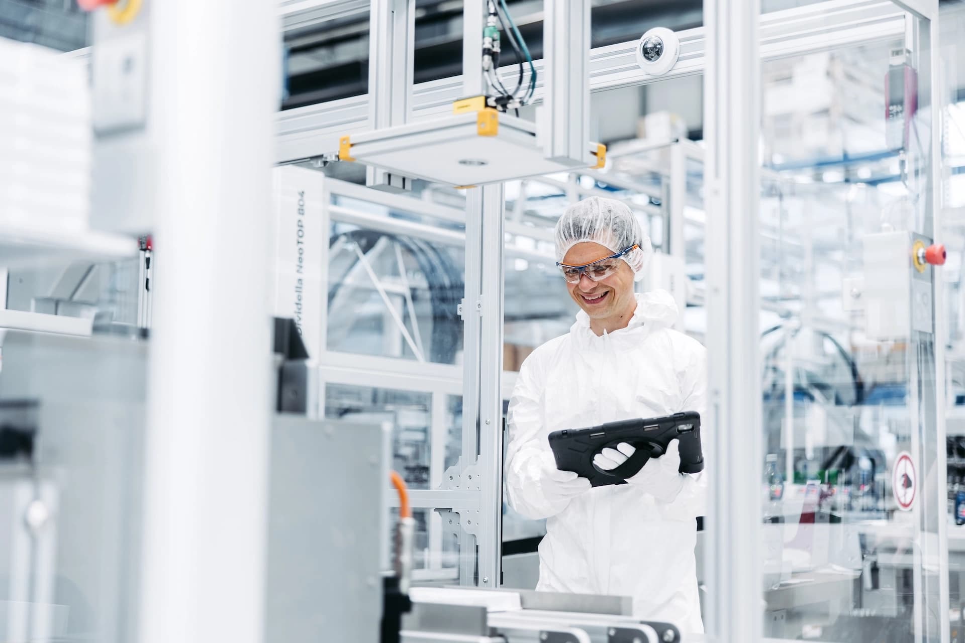 a Körber employee in a lab environment dressed in safety gear