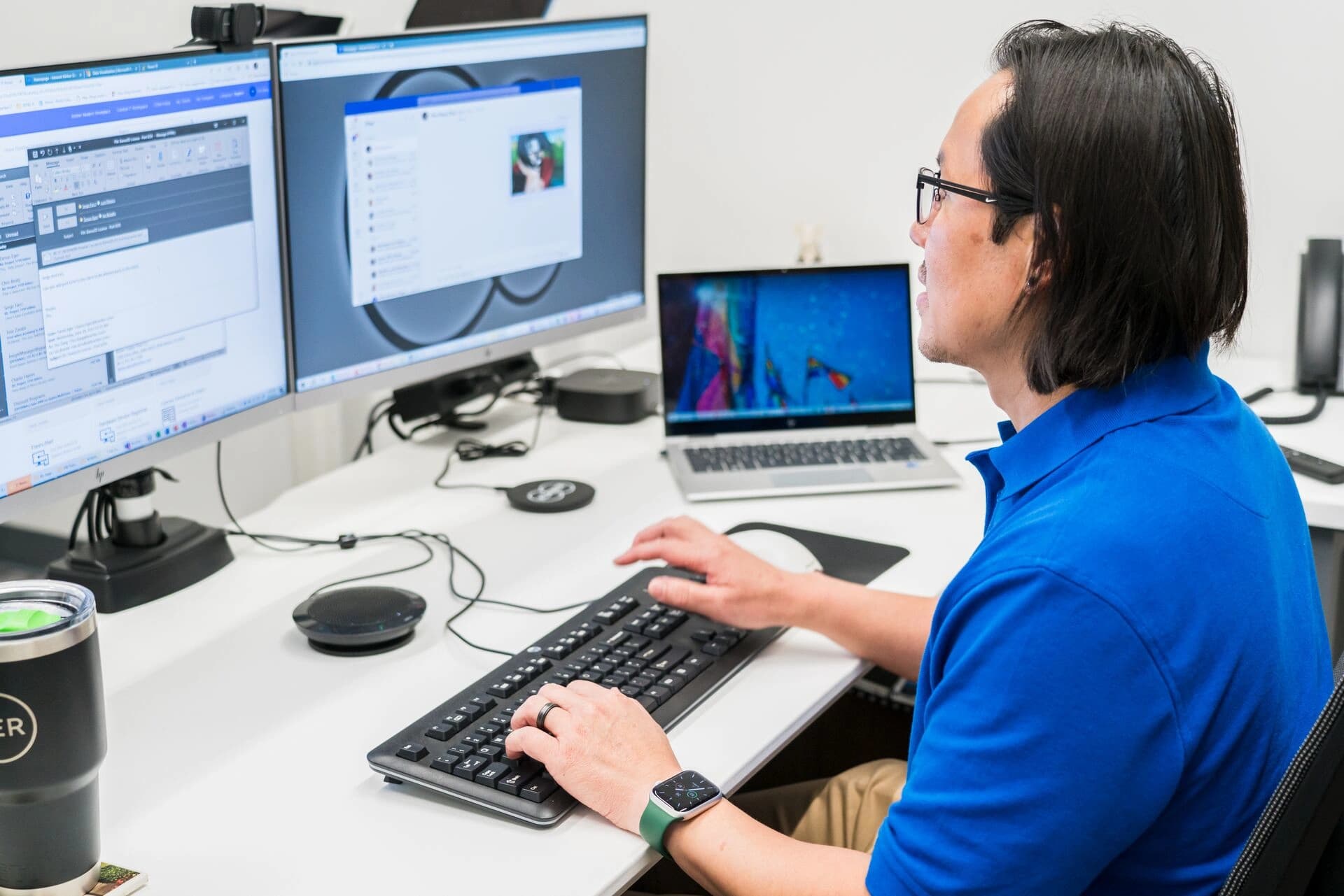 a Körber employee working on a computer