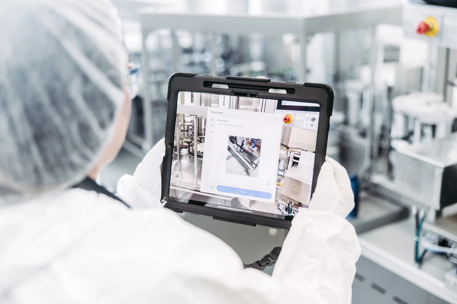 a Körber employee holding a tablet with pharma line optimizer
