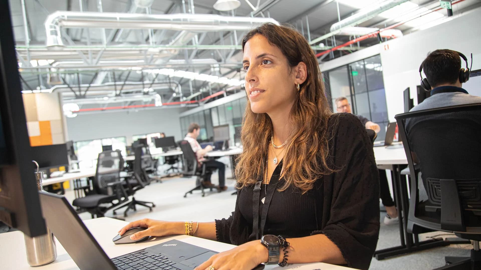 A woman working on Körber cyber defense center