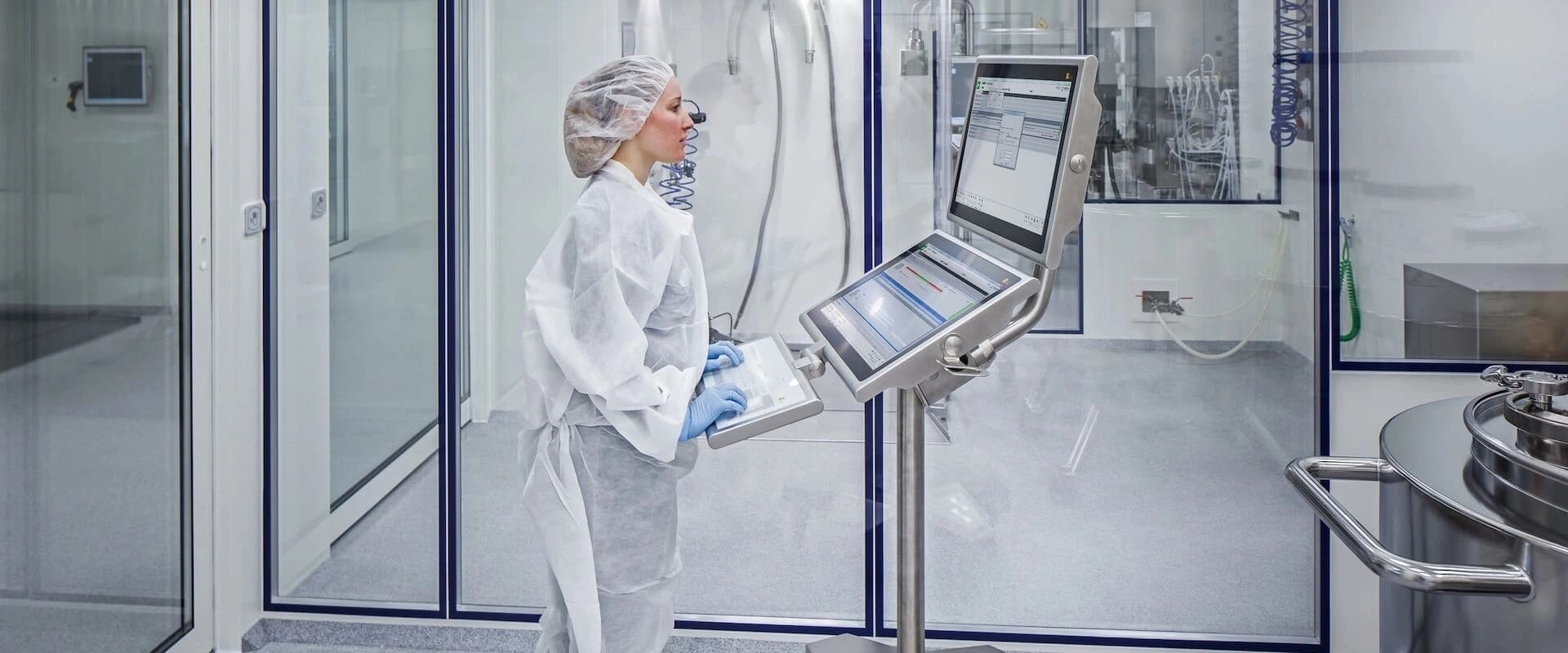 a woman in a lab environment working on PAS-X MES