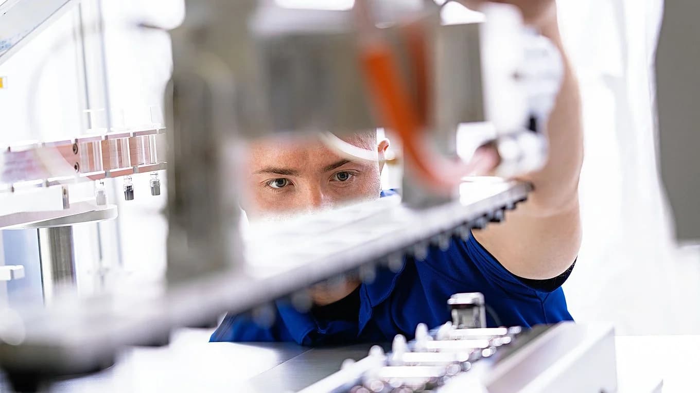 Körber employee working with a pharma handling machine.