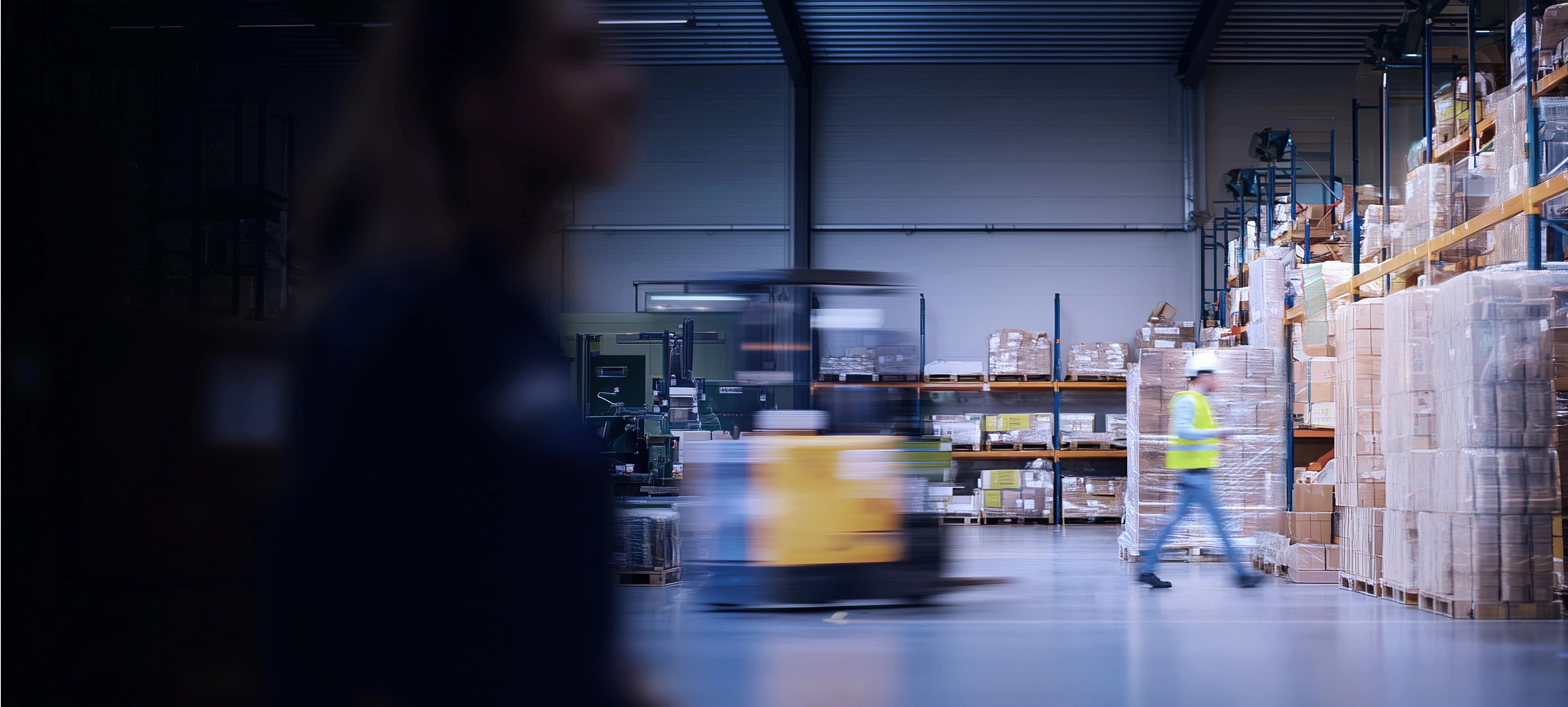 People in a warehouse with a forklift