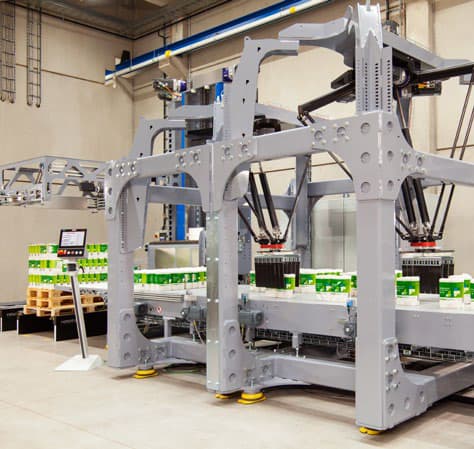 A machine operates on a conveyor belt inside a warehouse, processing items efficiently.