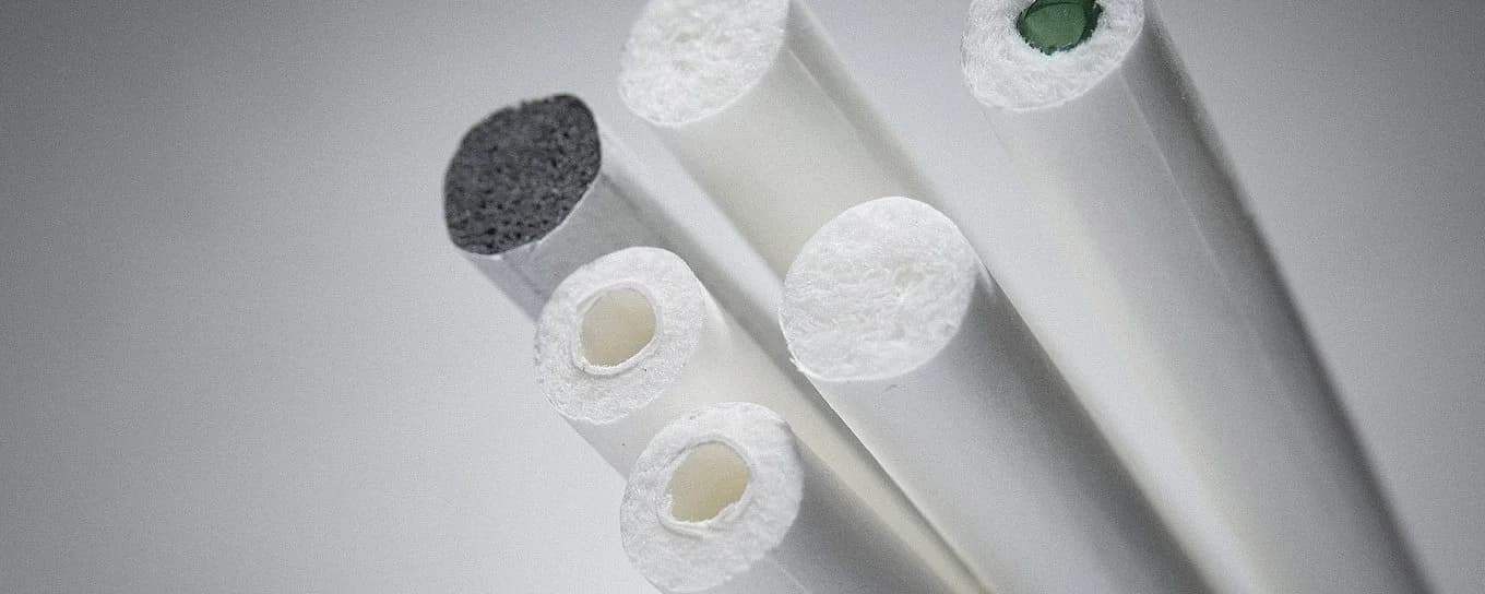 A collection of white and green biodegradable filters in different sizes displayed side by side.