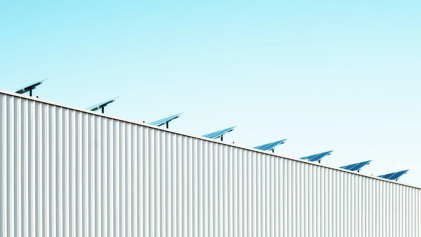 A group of solar panels installed on the side of a building, harnessing solar energy for sustainable power.