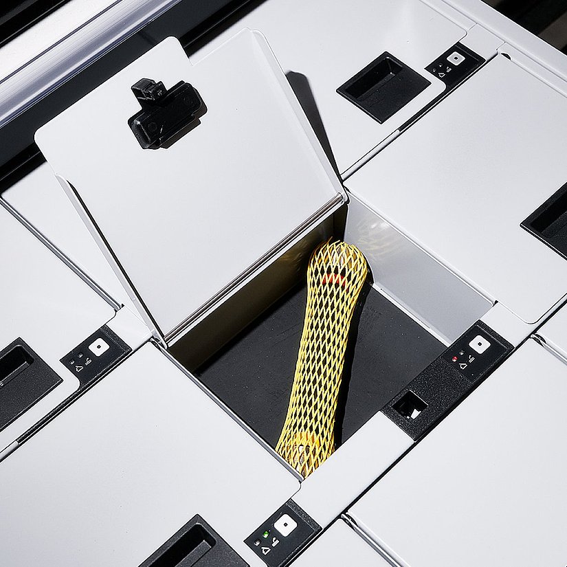 Photo of the automatic tool dispensing system at Hauni, a cabinet with computer-controlled flaps behind which the ordered tools are stored.