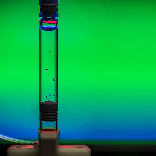 Photo of a filled syringe in which air bubbles float in the clear liquid.